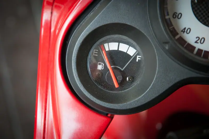 A car fuel gauge with the needle sitting on empty